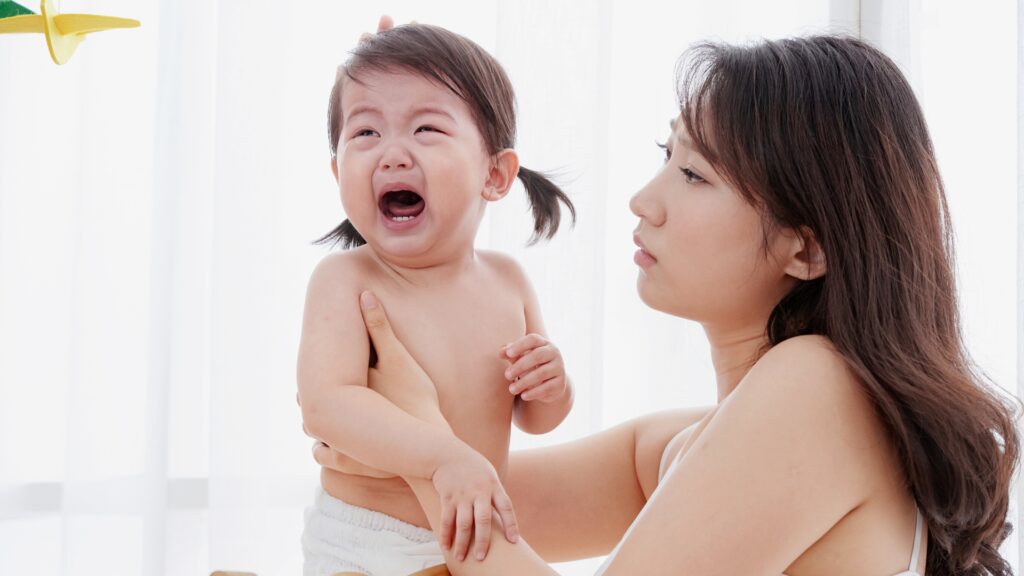 How To Discipline A 1 Year Old Featured Mother holding crying baby