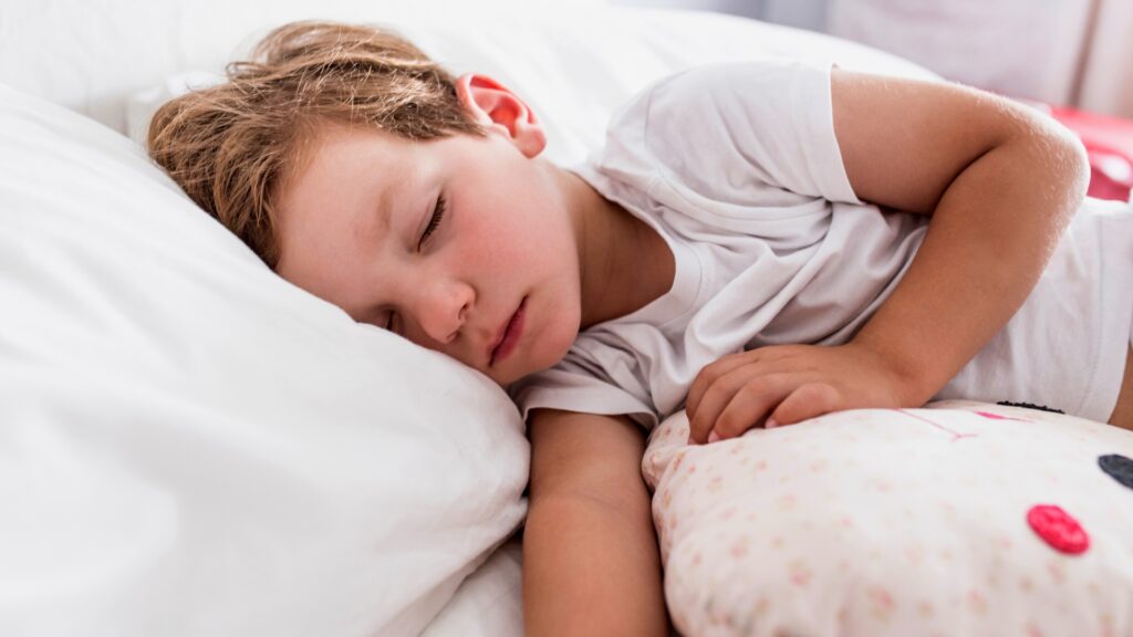 Sleep training a toddler calm boy sleeping in bed